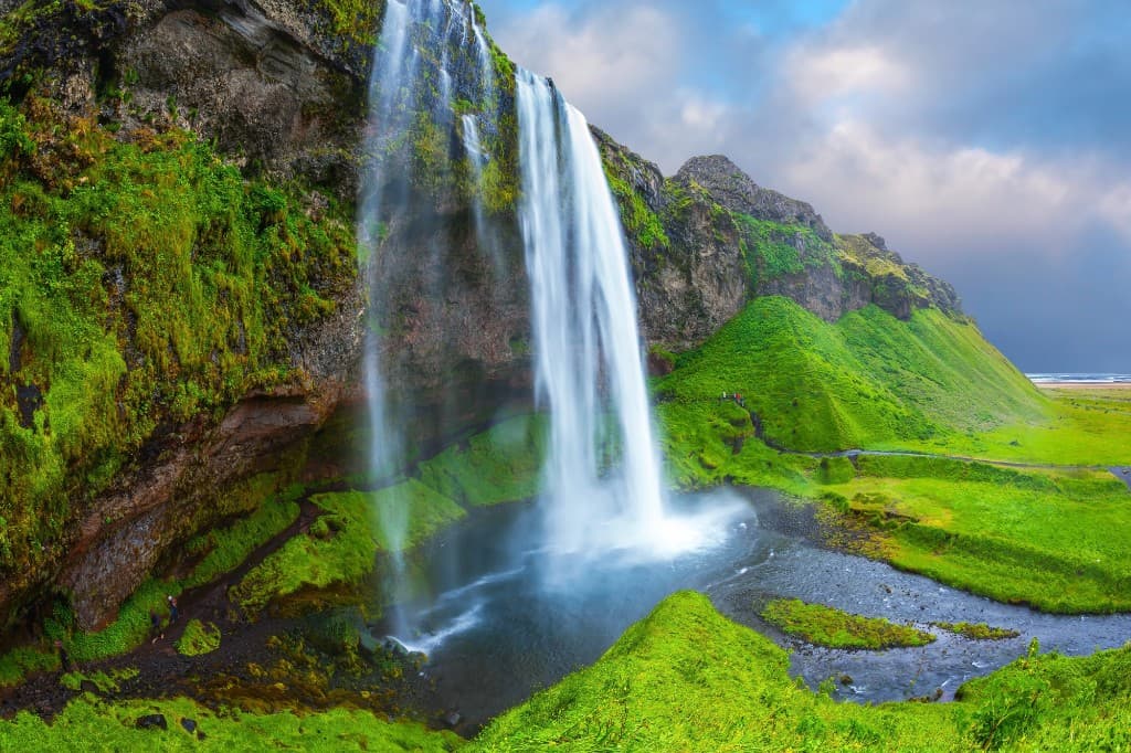 dramatic Iceland landscape with waterfalls, glaciers, volcanic mountains and northern lights