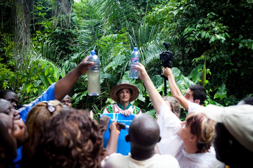 community gathering in tropical village, water moment, cultural immersion